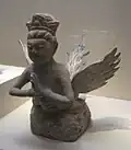 A winged kalavinka made of grey pottery