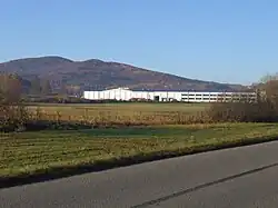 Grodzisko Mountain. In the foreground, the packaging factory in Zegartowice