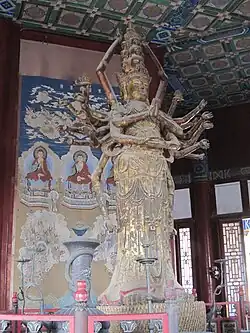 Ming dynasty (1368-1644) statue of Qianshou Qianyan Guanyin at the Foxiang Ge (Tower of Buddhist Incense) of the Summer Palace, Beijing, China.