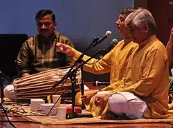 Gundecha Brothers (2012). Left to right: youngest brother Akhilesh Gundecha (Pakhawaj), younger brother Ramakant Gundecha (Vocal), elder brother Umakant Gundecha (Vocal)