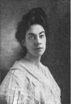 20th-century B&W portrait photo of a middle-age woman wearing a pale blouse, and her dark hair in an up-do.