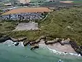 Aerial view of Gwithian Beach with surfers, Cornwall, England.