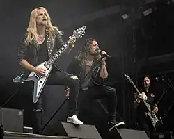 Elegant Weapons performing in 2023. L–R: Richie Faulkner, Ronnie Romero, Dave Rimmer