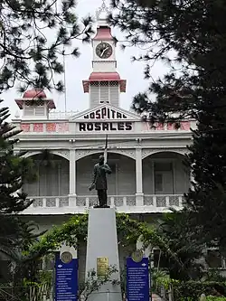A photograph of a state in front of Hospital Rosales