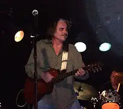 Singer Hal Ketchum, singing while strumming an acoustic guitar