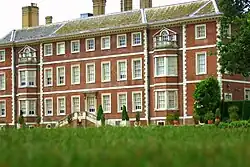 A photograph of the rear of the house from the gardens, illustrating newer brickwork from the renovation in the 1670s