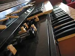 A close-up of the Hammond L-100 organ, with the drawbars in the foreground