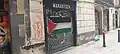 Graffiti outside a Levantine restaurant in Barcelona; the balloon reads 'Fuck Abu Mazen' in Palestinian Arabic