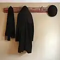 A coat rack made from clothes hooks and a mounting plate