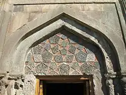 Intricately detailed tympanum above the portal of the zhamatun, an adaptation of Seljukid ablaq stonework[6]