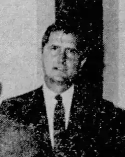 Black-and-white headshot of Whittington in a suit
