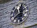Close up of the clock, which is the War Memorial in Haselor