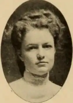 A young white woman with light wavy hair, in an oval frame