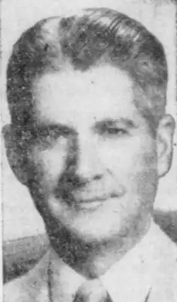 A 1955 portrait of Herbert Morrison sporting a suit, smiling for the camera