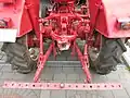 Back of the tractor: Towing hook and linkage. Before a plough can be used, a third arm must be attached to the linkage to gain a three-point linkage.