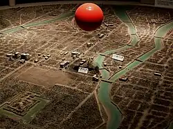 Former model of Hiroshima City flattened after the explosion. The red ball depicts the explosion point.