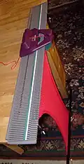 A flatbed home knitting machine