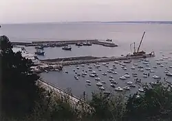 Two fishing craft within two quays and several pleasure craft outside.