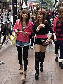 Image 112Young women in Hong Kong wearing layered street style with accessories and hairstyles influenced by Japanese gyaru and J-pop aesthetics, 2013. (from 2010s in fashion)