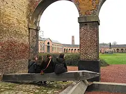 View of the oval courtyard and the statue of H. de Gorge, who early in the 19th century built the mining complex of Grand Hornu, which is an example of functional town-planning and evidence of the importance of the Industrial Revolution in Wallonia.
