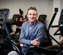 Humphrey Cobbold seated in a gym environment