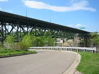 the bridge painted green and the street below it