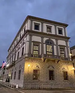 A view of the side of a three story building at night