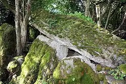 Moss-covered upright stones supporting a massive leaning stone roof slab