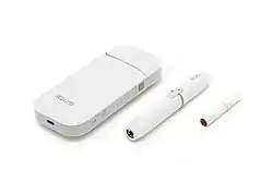 IQOS, consisting of a charger, holder, and tobacco stick.