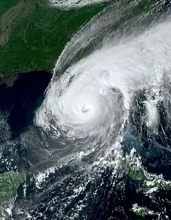 Satellite image of Hurricane Ian over the western coast of Florida, displaying a distinct, tightly wound spiral structure with a prominent eye.