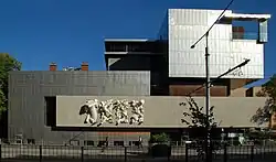 A cast bronze plaque architecture award fixed to a wall at the museum