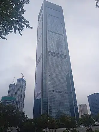 A towering square glass skyscraper