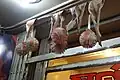 Leaves and balls of flower petals as nazar battu by a shop