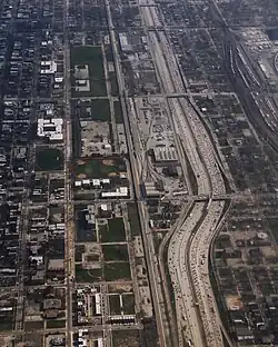 Aerial view of Fuller Park on the right half of the photo, depicting the Dan Ryan Expressway and the CTA Red Line