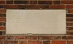 A descriptive stone plaque with worn lettering