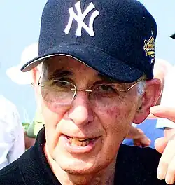 Irving Schwartz, wearing a New York Yankees baseball cap.