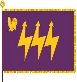 The traditional colour of the Eastern Finland Signals Battalion, part of the Karelia Brigade, has the branch colours of signals corps: purple and gold. The device featuring a western capercaillie is a throwback to the earlier designation as Central Finland Signals Battalion, with capercaillie being the heraldic symbol of that province. The main device, the three lightning bolts, is symbolic of communication.[23]