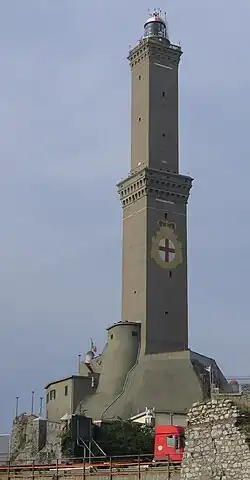 Tall, slender tower with several tiers, dark stone