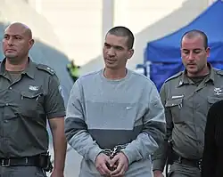 Itzik Abergil, center, escorted by Israeli police officers, January 12, 2011
