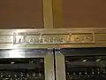 Johnniac name badge on computer frame