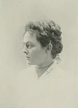 19th-century B&W portrait photo of a woman with her hair in an up-do, wearing a pale, fitted blouse.