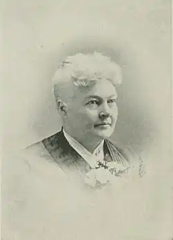 B&W portrait photo of an old woman with her hair in an up-do.
