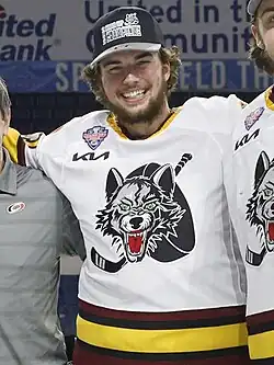 Ice hockey player in a Chicago Wolves jersey smiling