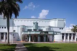 A white and pale green theater building