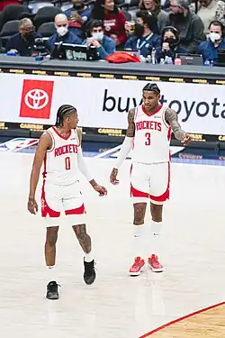 Man dunking a basketball.