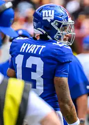 Hyatt in high school wearing his helmet on a football field