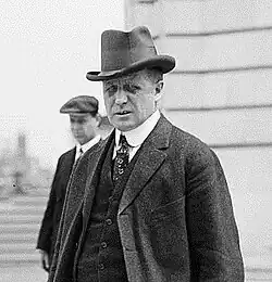 Top half of man with sullen face in formal attire
