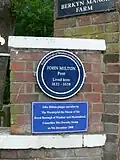 John Milton blue plaque at the entrance to Berkyn Manor