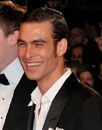 Kortajarena smiling towards the camera, wearing a black coat