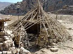 Reconstruction of an early PPNB semi-buried round house in Beidha, Jordan.